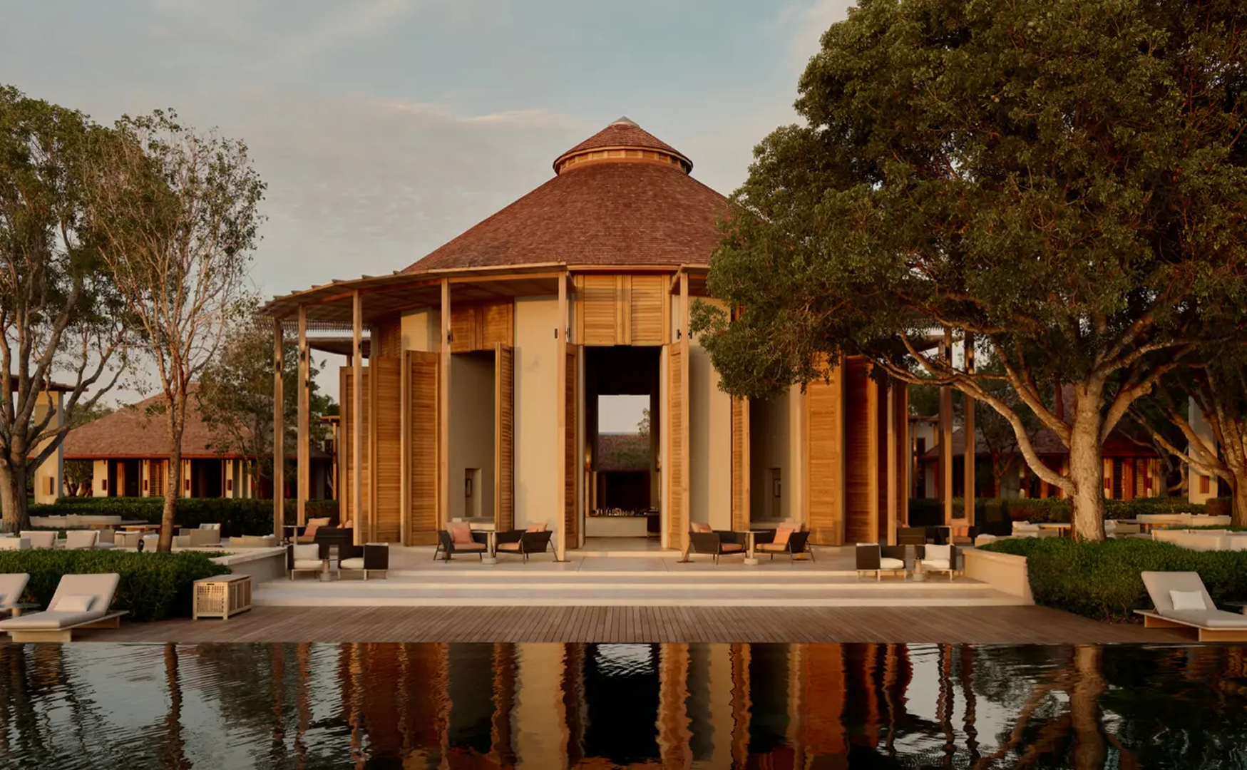 Hilton resort pavilion reflected in a pool at dusk